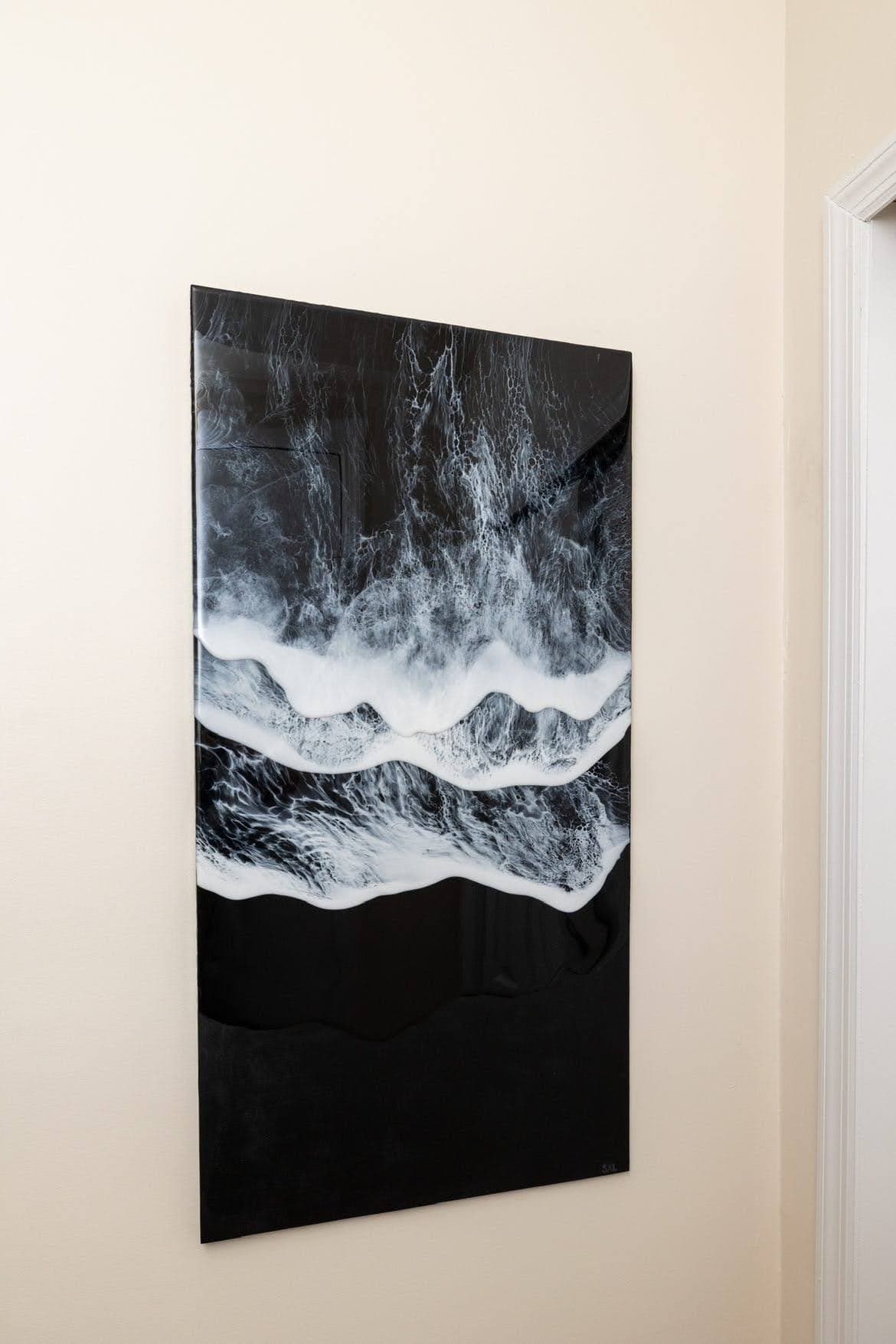 Large black-and-white abstract canvas of waves